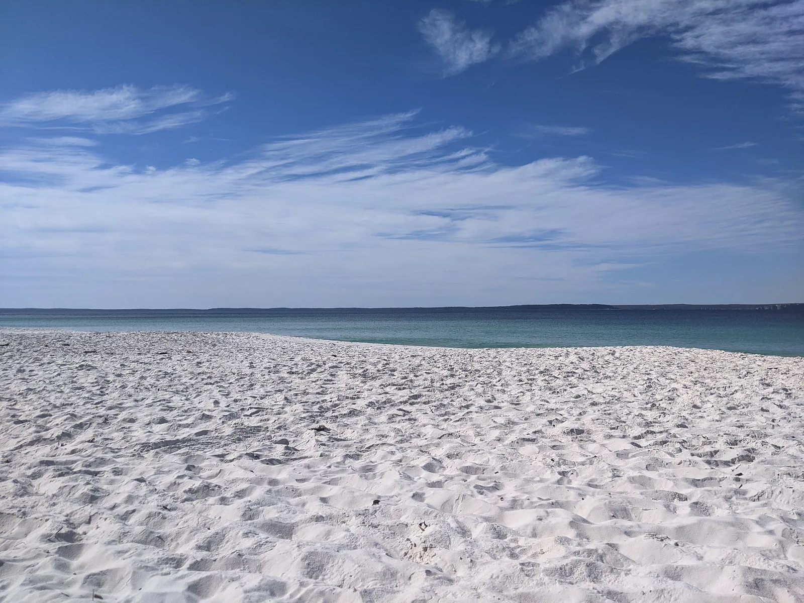 Hyams Beach is famous for its powdery white sand and is located at the southern end of Jervis Bay National Park. Dolphins, seals and penguins cavort in the crystal clear water of its marine park. Image possibly taken within Booderee National Park. Image is definitely not taken in Jerevis Bay NP